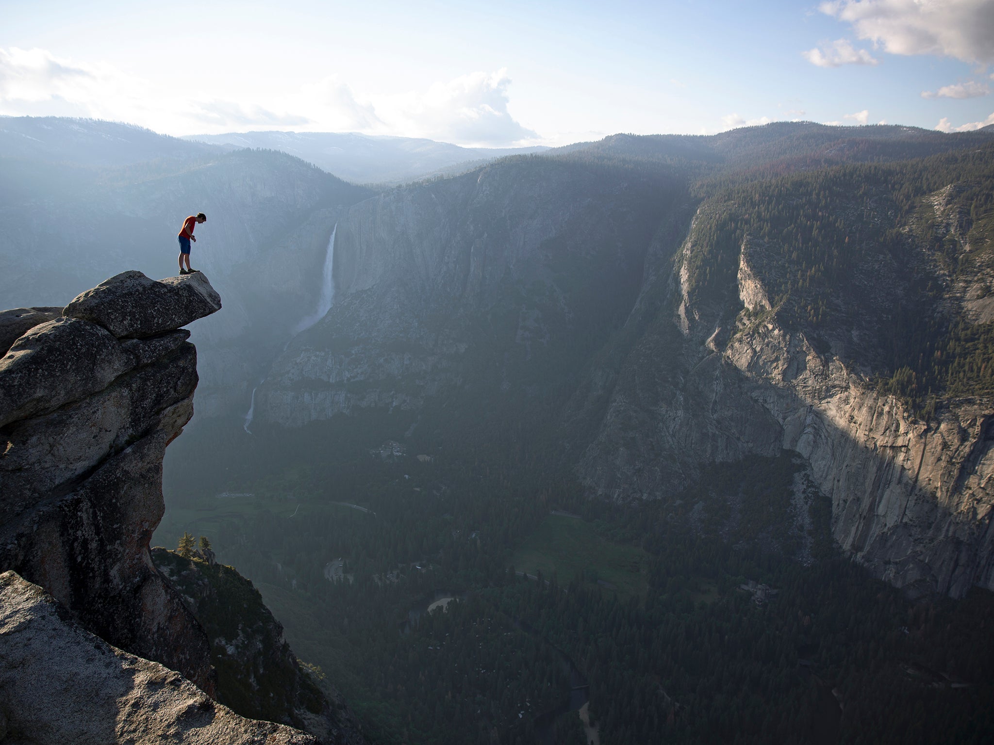 Honnold peers over the edge of Glacier Point in Yosemite national park