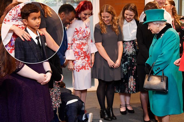 Nine-year-old Nathan Grant crawls away during a visit by Queen Elizabeth II to Coram, the UK's oldest children's charity, to open the Queen Elizabeth II Centre at its base in central London.