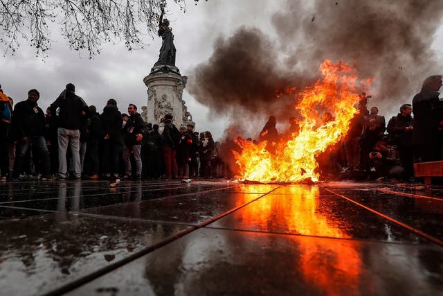 A rubbish bin burns on Place de la Republique as students demonstrate against the increase of the subscription fees for foreigners students, in Paris, France, 7 December 2018. This movement takes place while the government is facing a major contestation by the so called movement of the Gilets Jaunes (Yellow Vests).