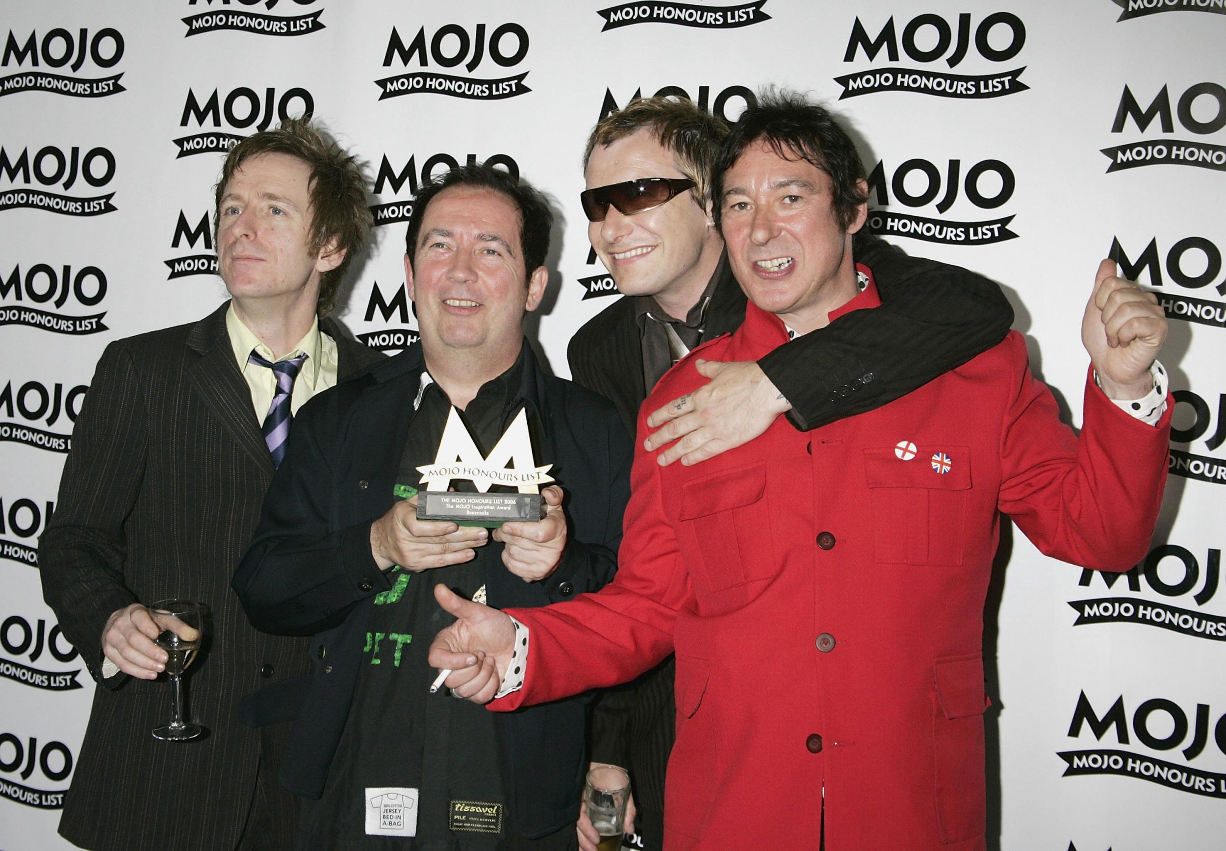Shelley (second left), and fellow Buzzcocks Danny Farrant, Steve Garvey and Steve Diggle pose with The Mojo Inspiration Award in June 2006