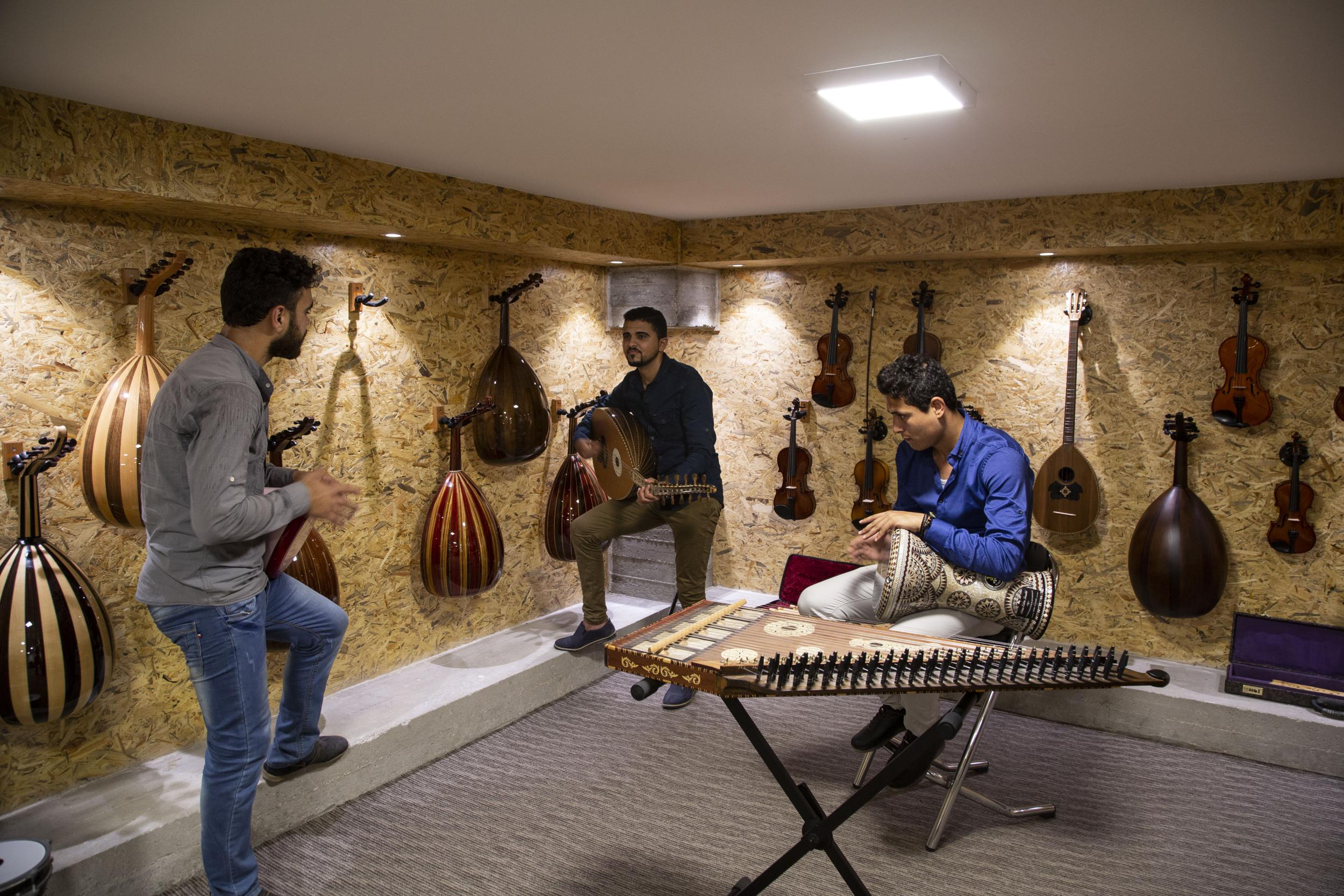 Young Palestinians play instruments in Gaza’s first music shop