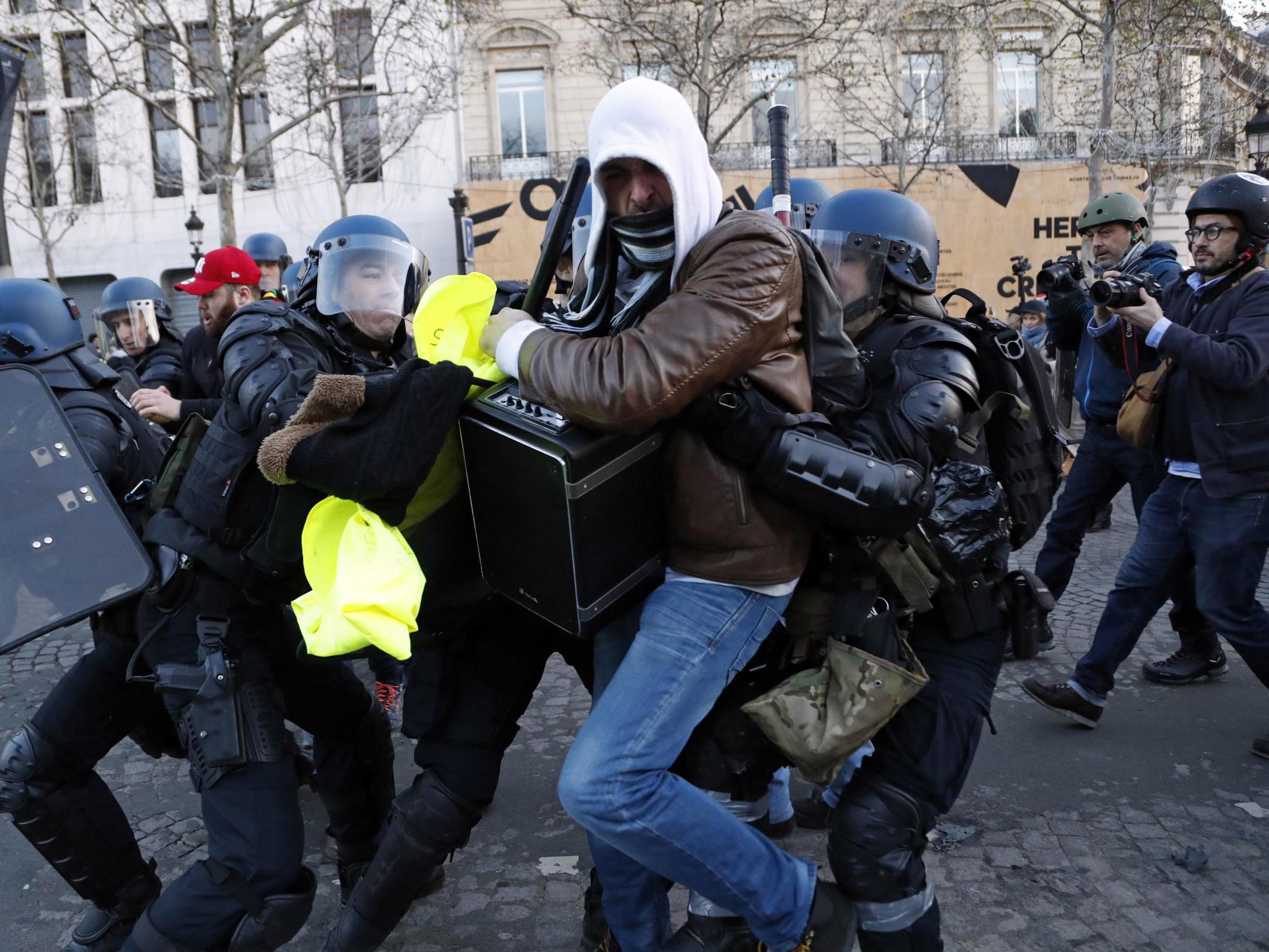 Police apprehend a protester in Paris