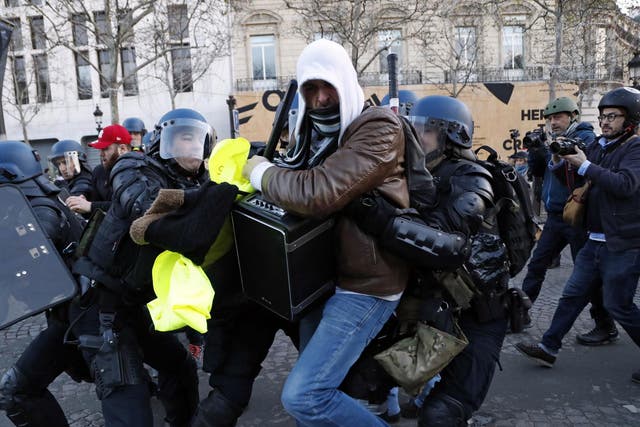 Police apprehend a protester in Paris