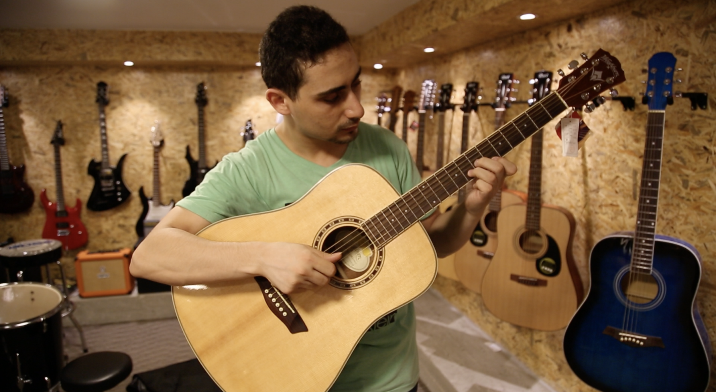 Raji Jaru, the owner of Gaza’s first music shop, plays the guitar