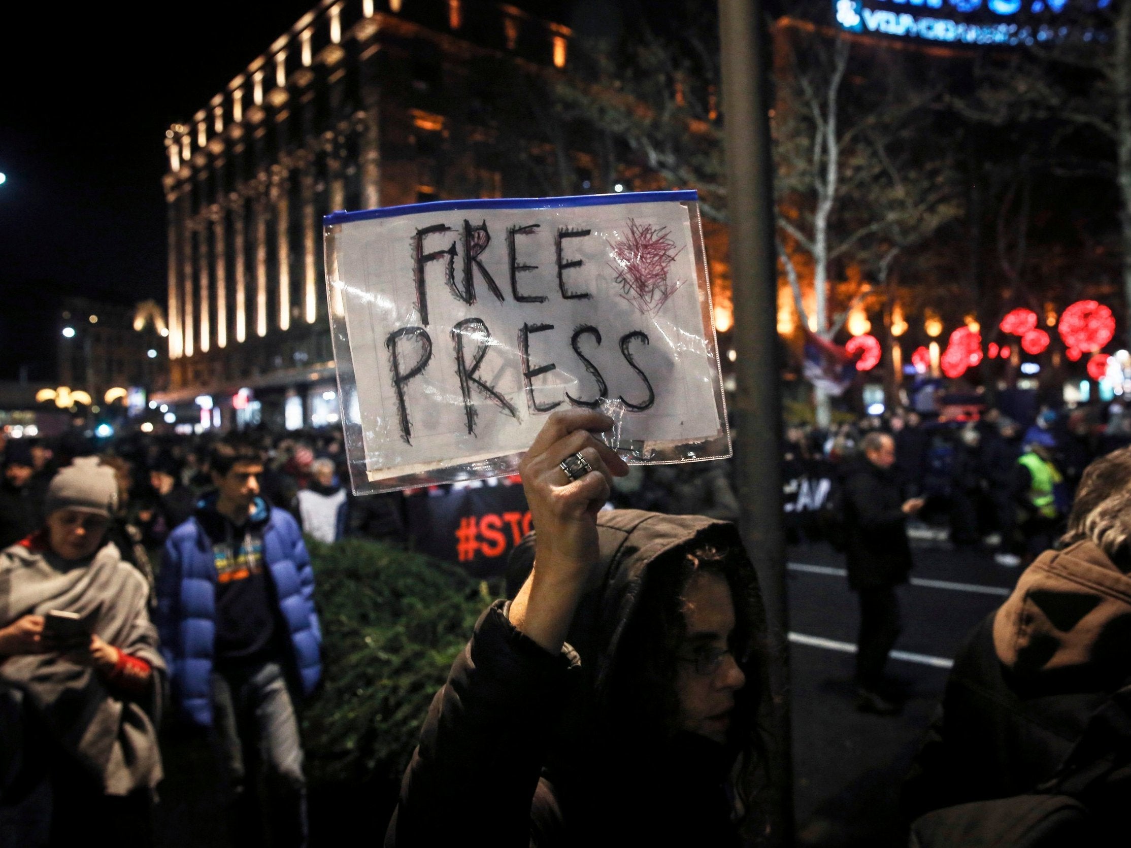 A woman holds a placard during a protest against violence on 8 December, 2018 in Belgrade.