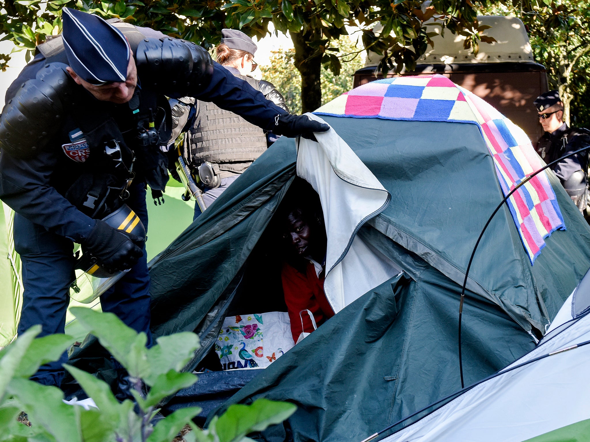 Refugees are evacuated by CRS riot police from a camp in Nantes in July 2018