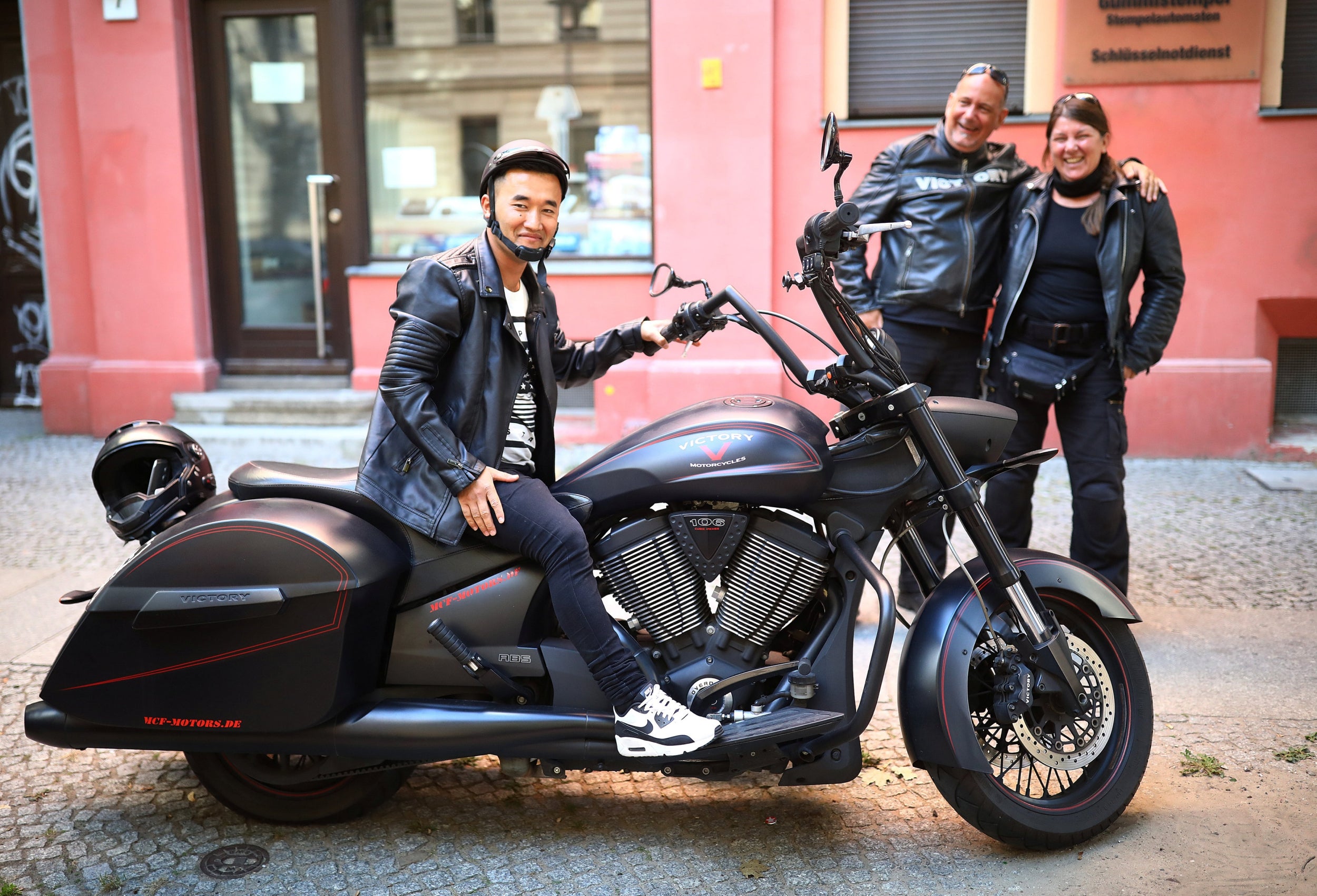 Afghan migrant Ali poses on the motorbike of his German friends Chris and Jochen