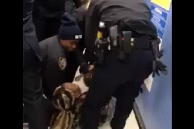 A video showing police officers trying to remove a woman’s 1-year-old son from her grasp has ignited a fury on social media