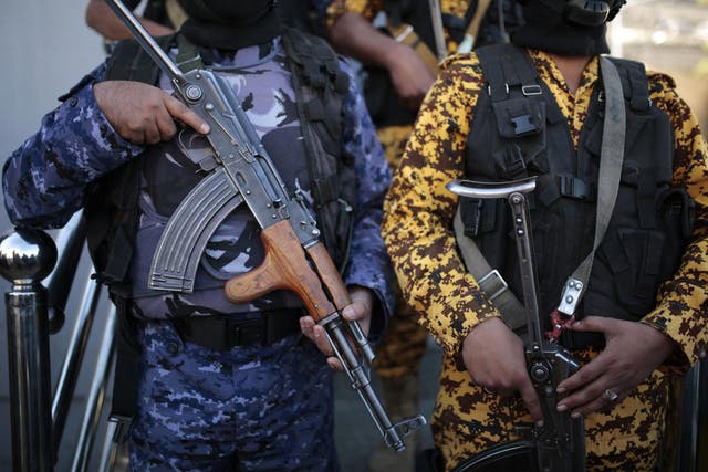 Yemeni police troopers stand guard at a door of the UN offices in Sanaa uring a protest calling for the reopening of Sanaa airport to receive medical aid