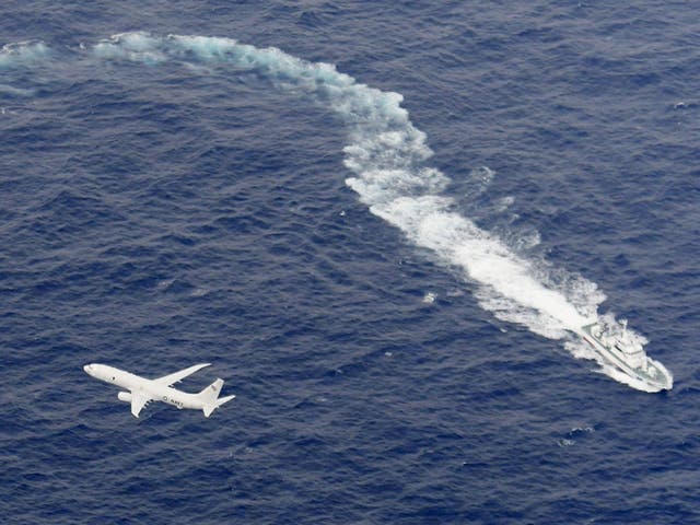 A Japan Coast Guard patrol vessel and US Navy airplane conduct search and rescue operation at the area where two US Marine Corps aircraft have been involved in a mishap in the skies, off the coast of Kochi prefecture, Japan