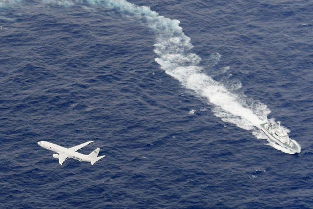 A Japan Coast Guard patrol vessel and US Navy airplane conduct search and rescue operation at the area where two US Marine Corps aircraft have been involved in a mishap in the skies, off the coast of Kochi prefecture, Japan