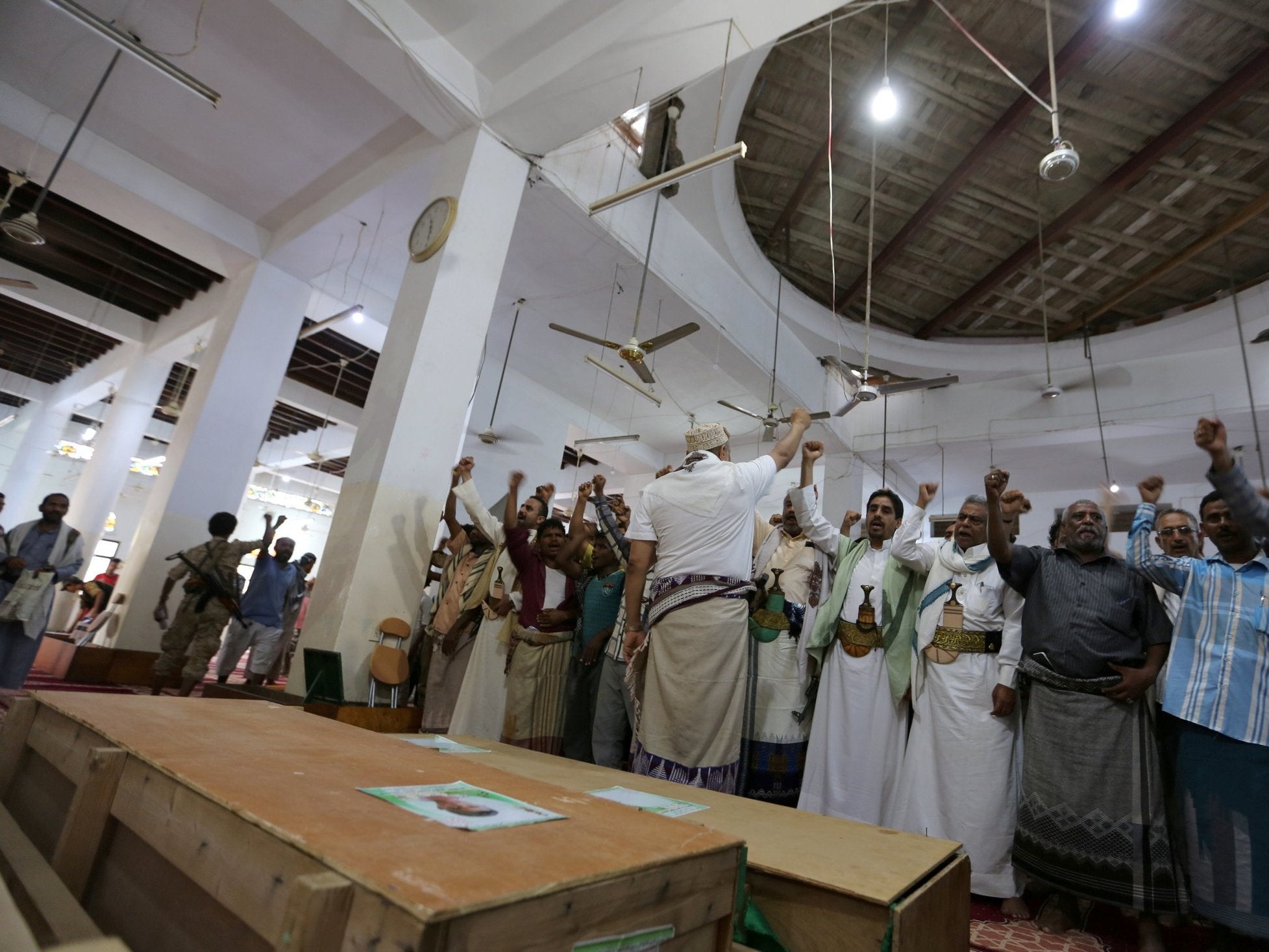 Mourners shout slogans during the funeral of victims who were killed by shells that hit a house in Hodeidah on 10 December
