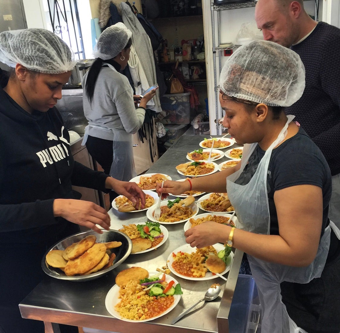 Helpers at the Brixton Soup kitchen prepare meals for people who are homeless