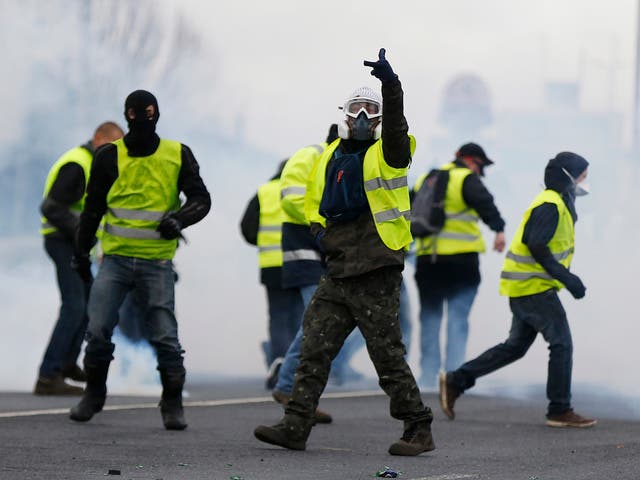Yellow vest protesters wear gas masks in protests in Mondeville near Caen