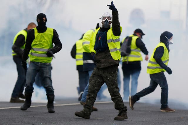 Yellow vest protesters wear gas masks in protests in Mondeville near Caen