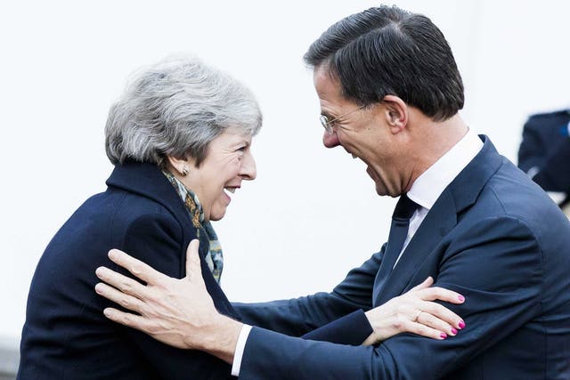 The prime minister is welcomed by Dutch leader Mark Rutte