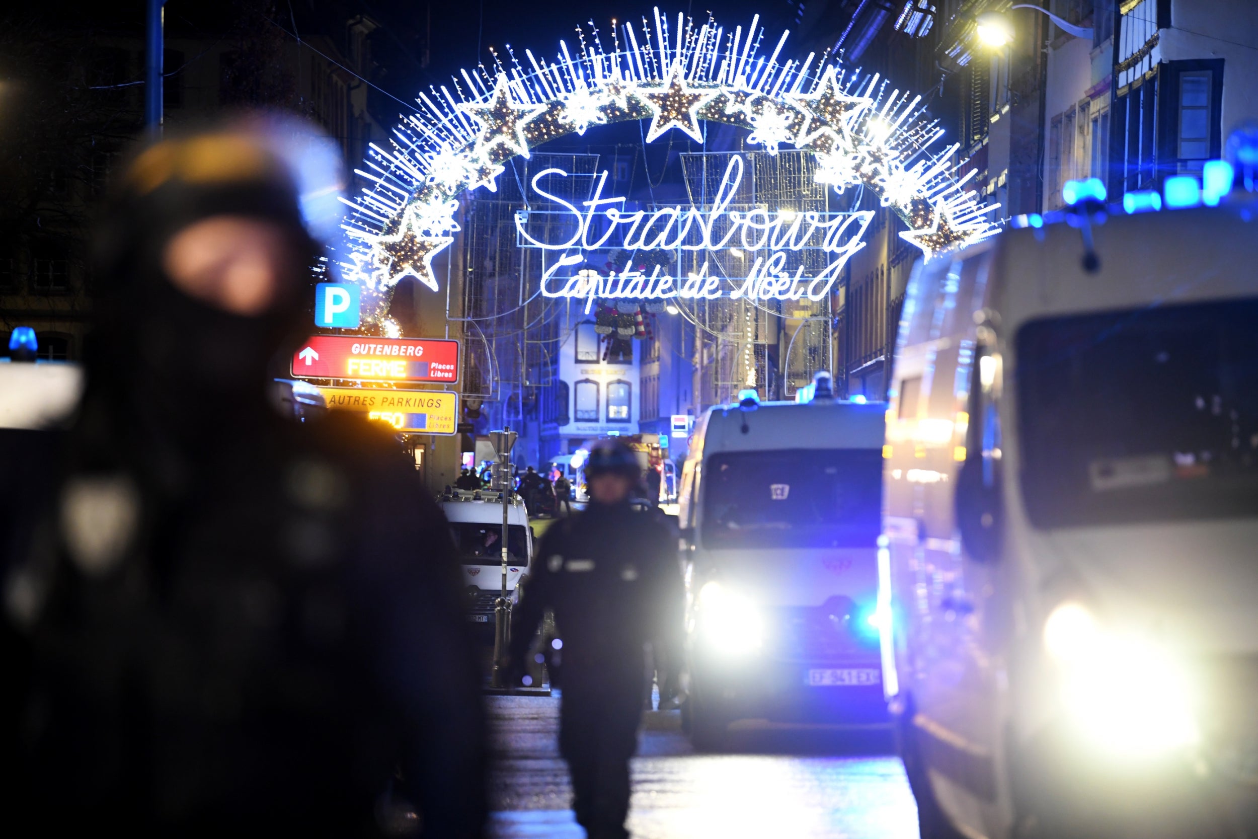Police officers stand guard near the Christmas market