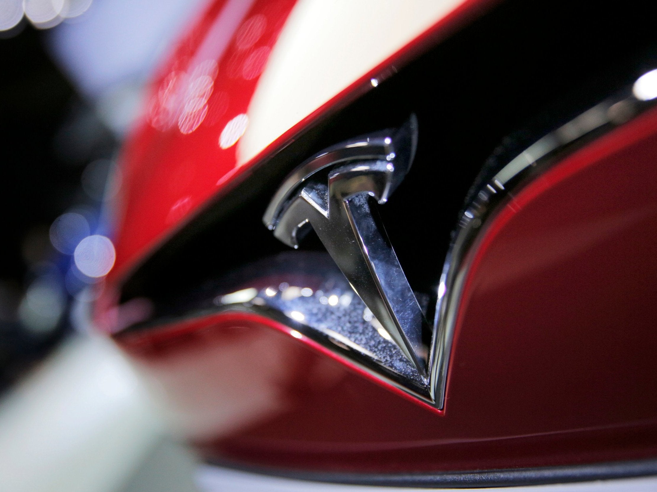 Tesla shares fall 9% as electric car company slashes prices | The Independent