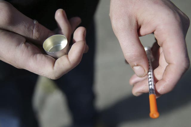 A fentanyl user holds a needle near Kensington and Cambria in Philadelphia