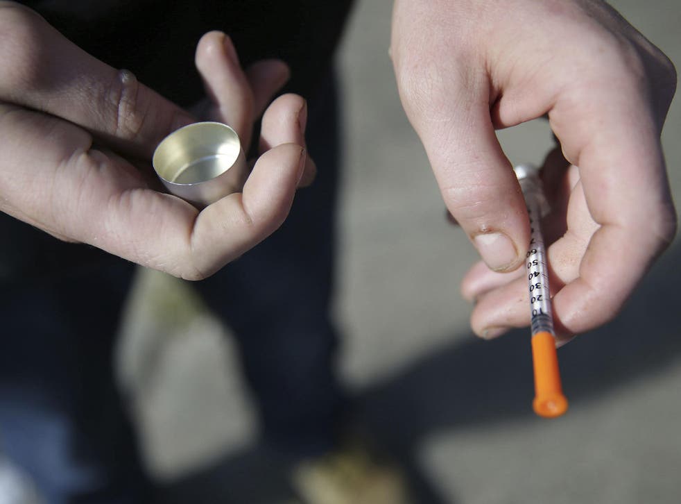 A fentanyl user holds a needle