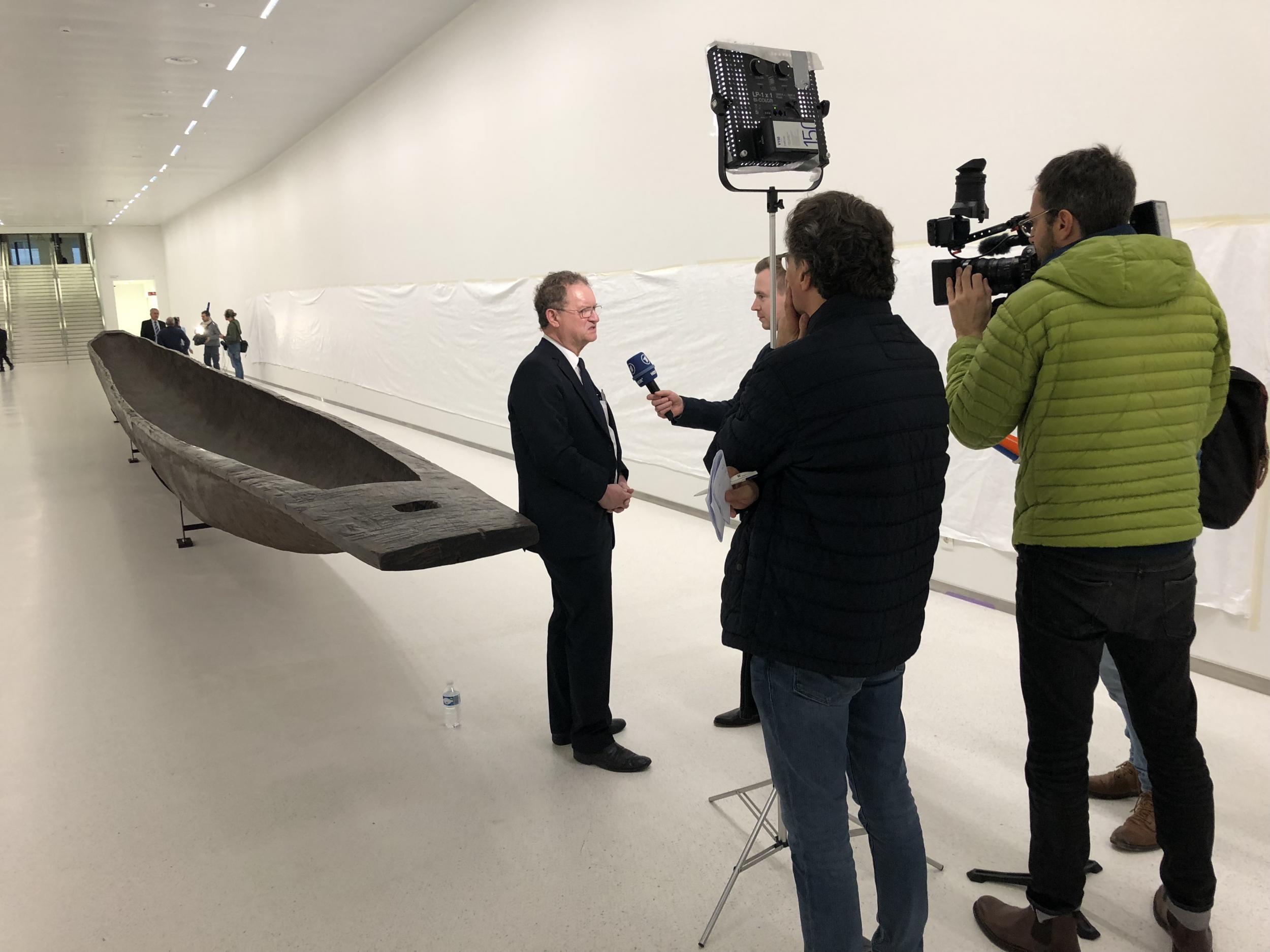 Guido Gryseels, director-general of the AfricaMuseum, stands beside a 74ft-long pirogue