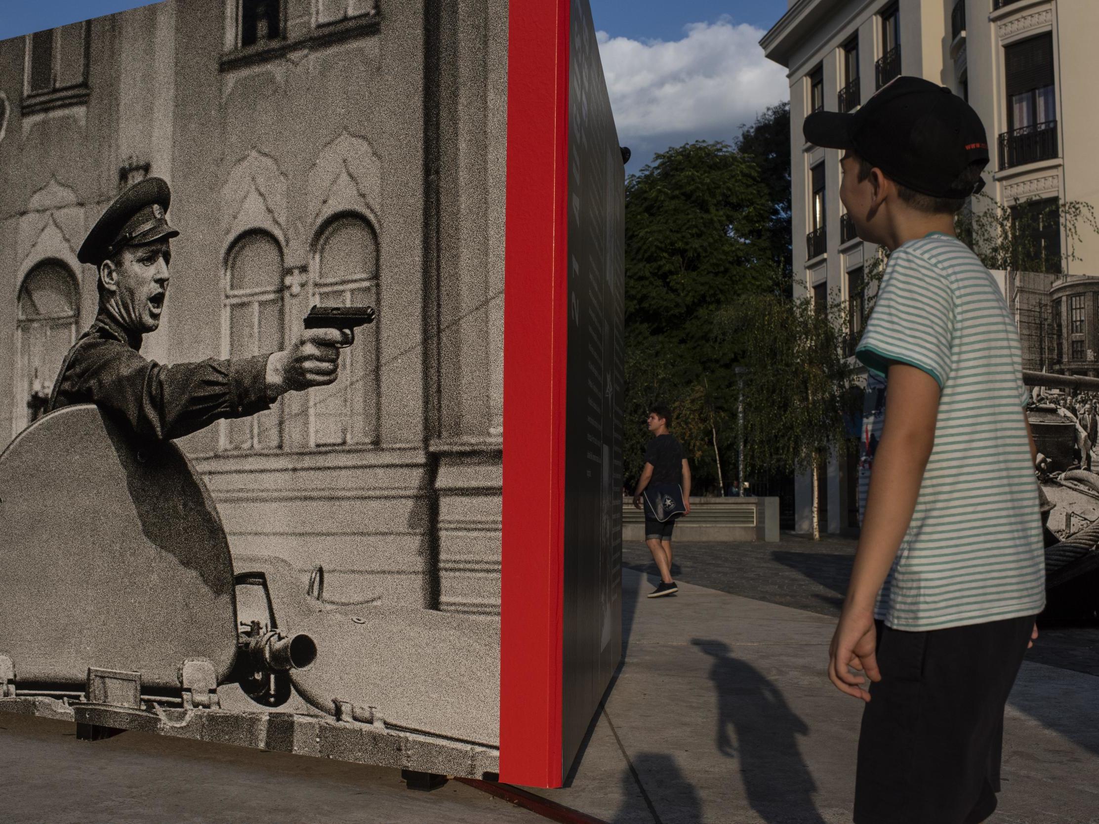 A boy looks at a photography exhibit on Sept. 13, 2013. The exhibit, in Bucharest, Romania, commemorates the Soviet invasion of Prague in 1968