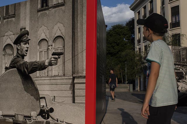 A boy looks at a photography exhibit on Sept. 13, 2013. The exhibit, in Bucharest, Romania, commemorates the Soviet invasion of Prague in 1968