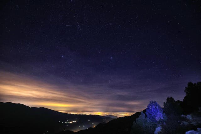 A picture shows stars in the sky during the annual Geminid meteor shower on the Elva Hill, in Maira Valley, near Cuneo, northern Italy on 12 December, 2015.