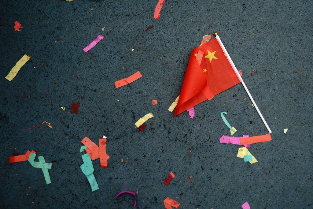 A Chinese flag lays on the ground in New York, 16 February 16, 2018
