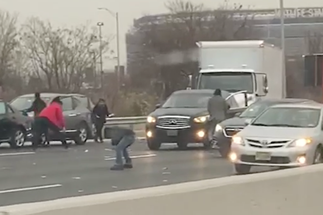 People were seen walking on the highway amid trucks and cars.