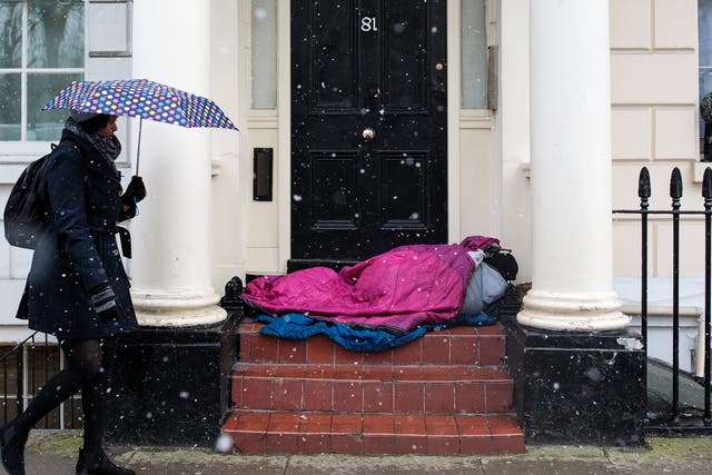 A person sleeps rough in a London doorway in February