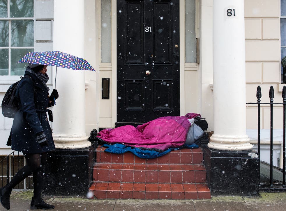 A person sleeps rough in a London doorway in February