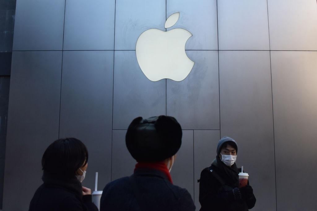 People walk past an Apple store in Beijing on 11 December, 2018