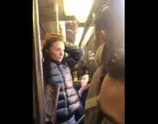 Woman filmed hurling kicks and racial slurs at Asian commuter