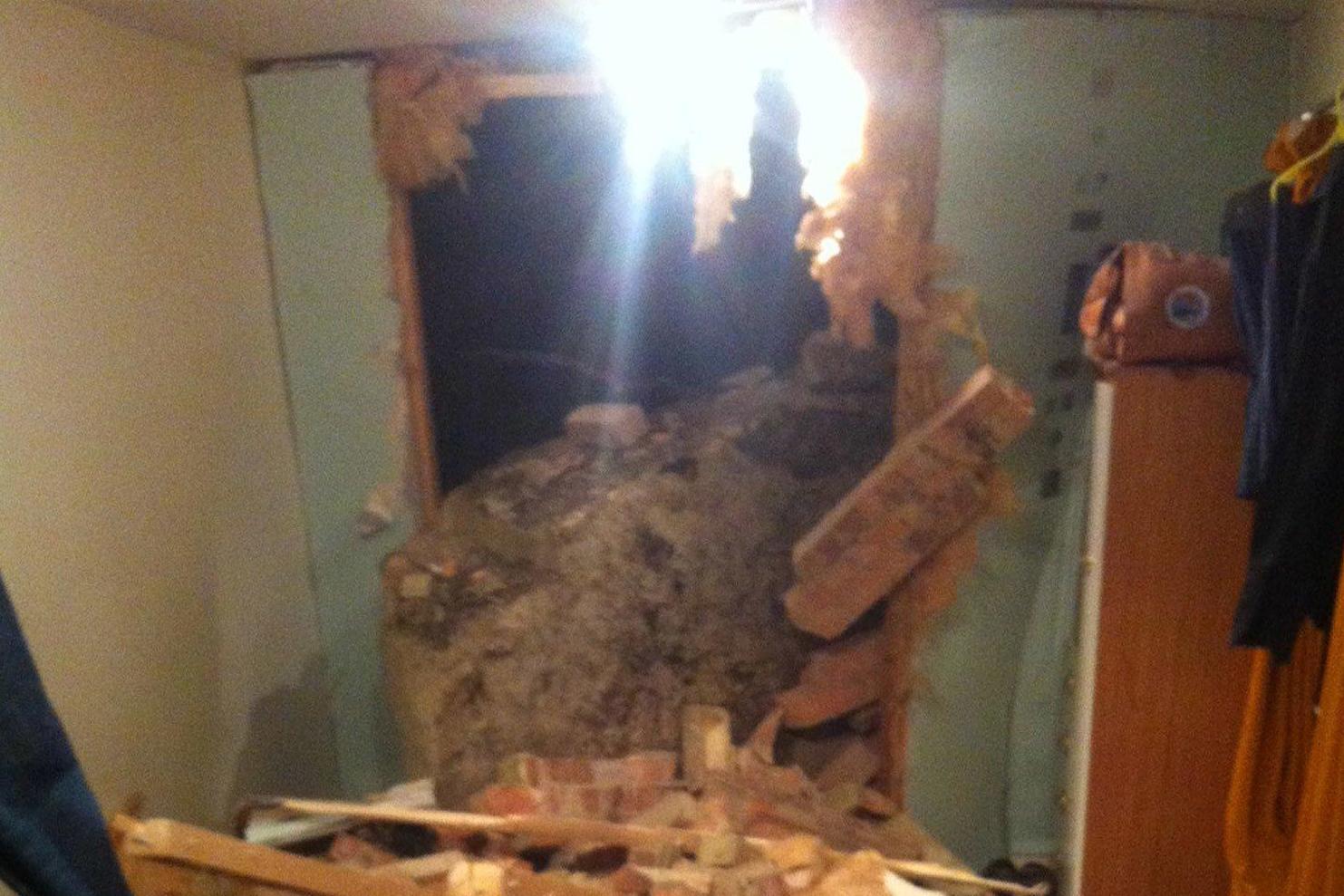 The destruction caused to a bedroom after a giant boulder fell and smashed through the wall of a home in Hastings on Thursday