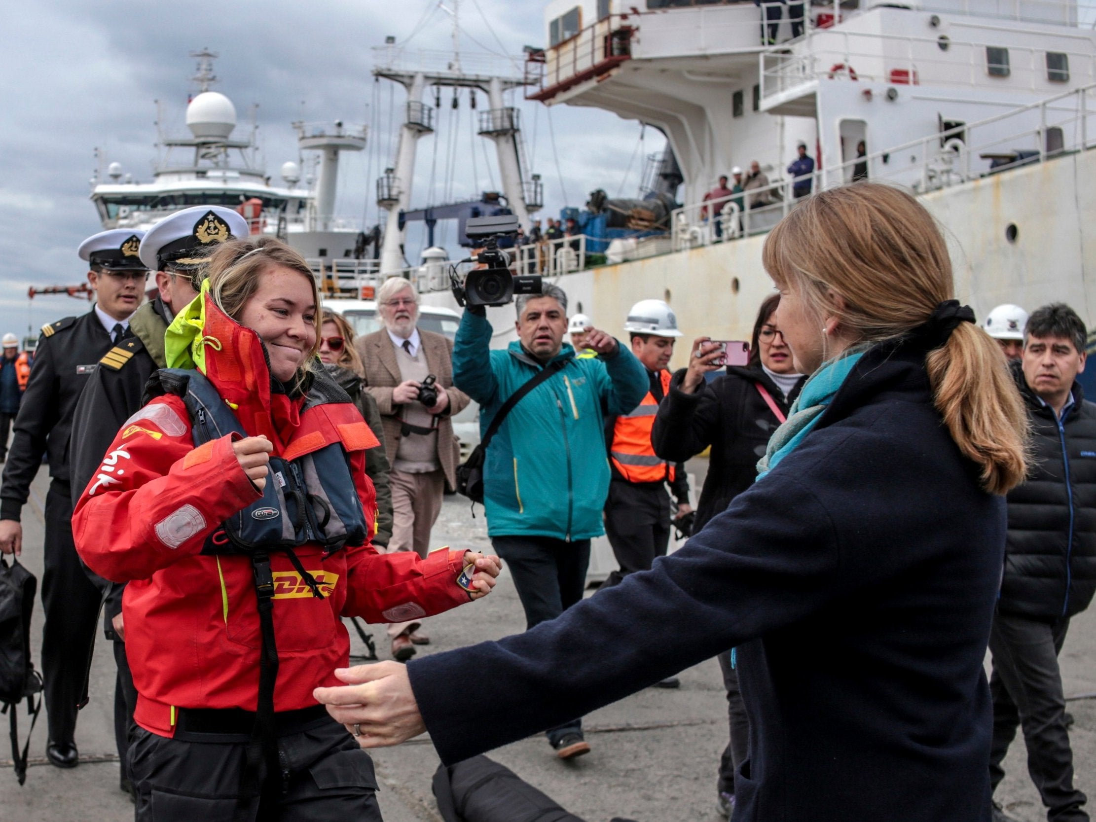 Susie Goodall walks into the waiting arms of her mother after arriving on land