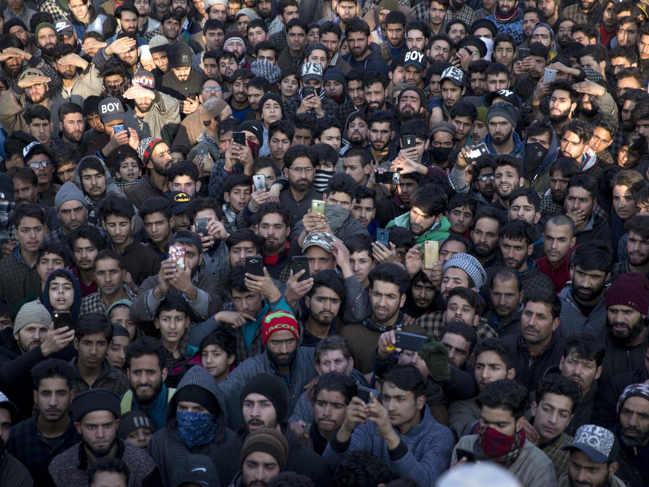 Kashmiri villagers attend the joint funeral of a civilian and rebel killed in a gun battle