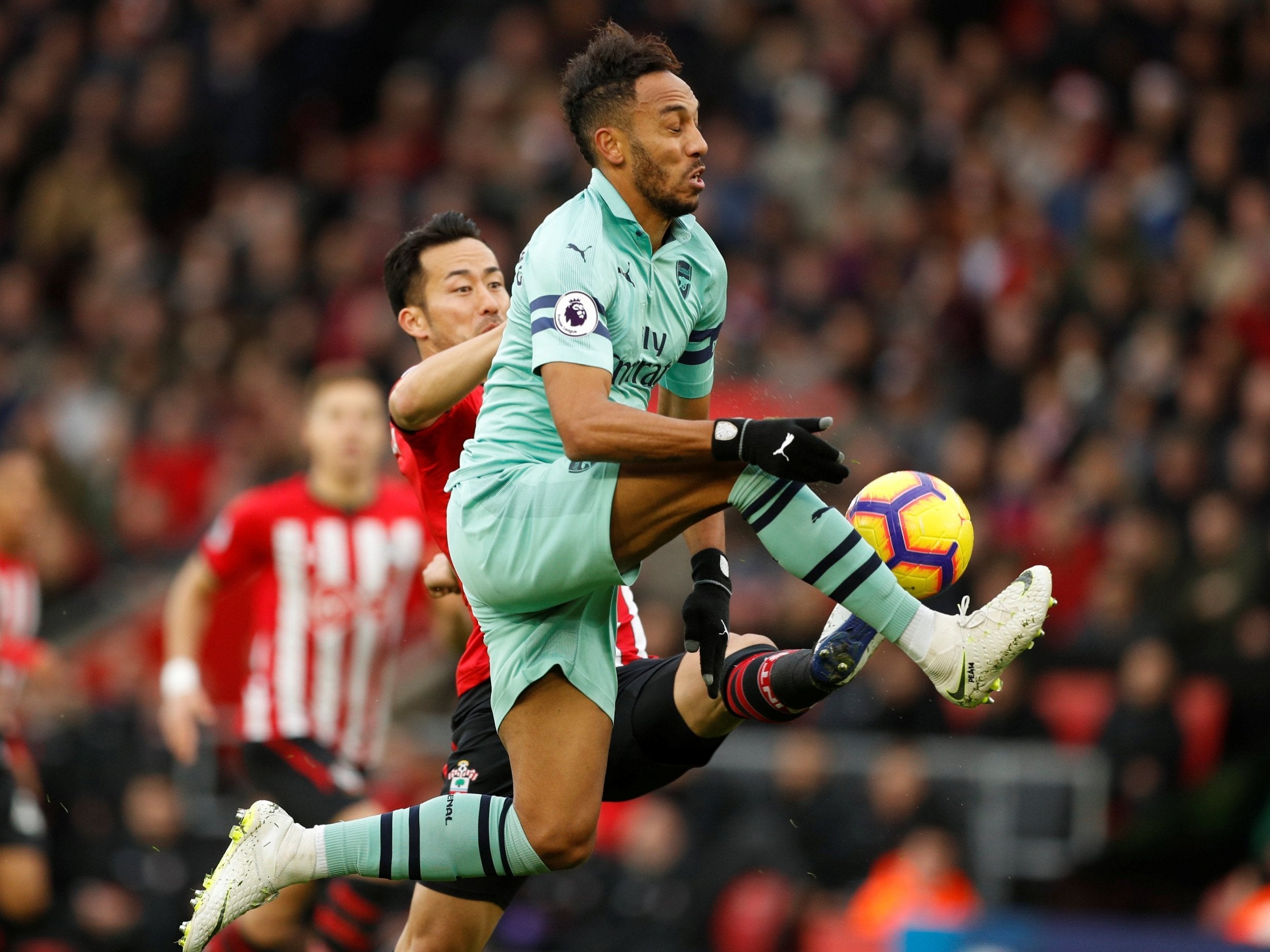 Pierre-Emerick Aubameyang is challenged by Maya Yoshida
