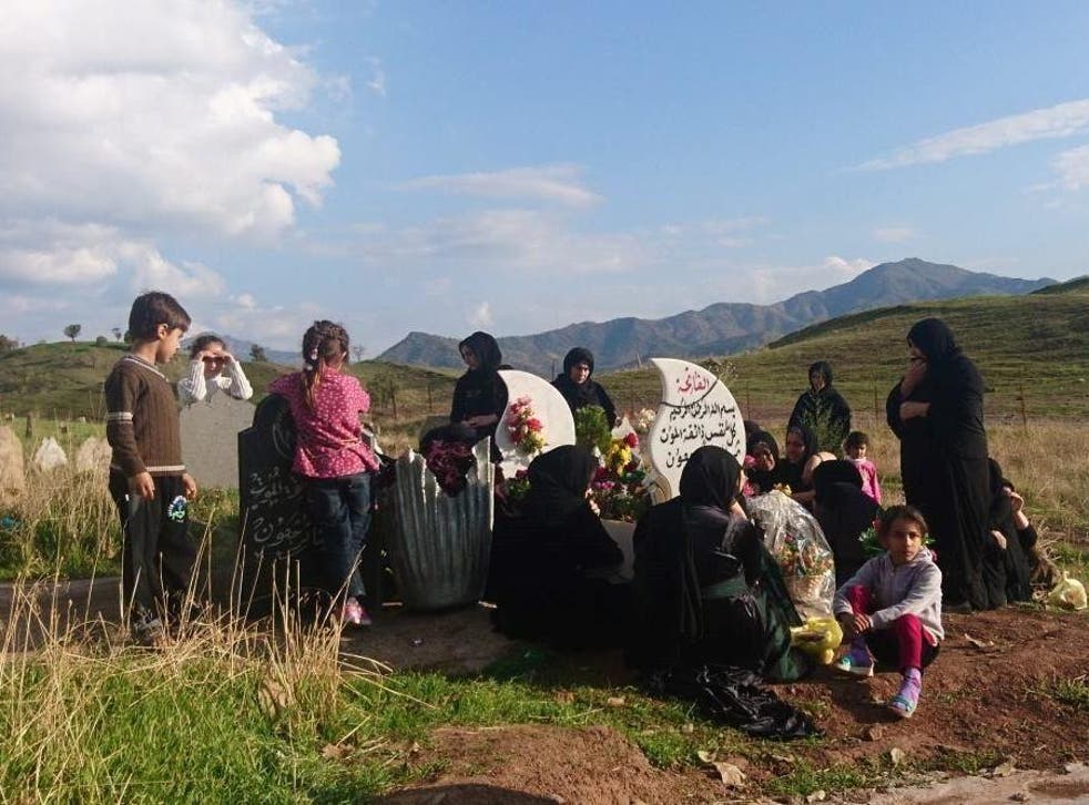 Family mourning Himdat Osman Darwish – a Kurdish villager killed during a bombing – by his grave