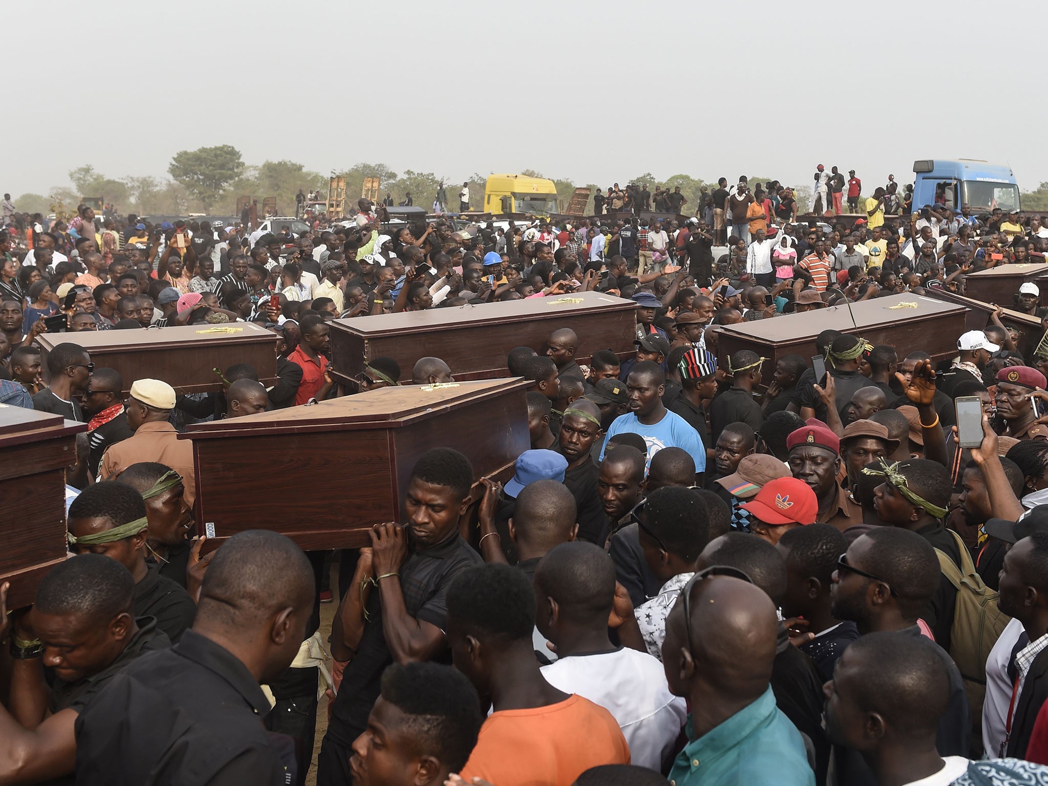 Pall bearers carry coffins during the funeral service for people killed during clashes between cattle herders and farmers, on 11 January, 2018, in Ibrahim Babangida Square in the Benue state capital Makurdi