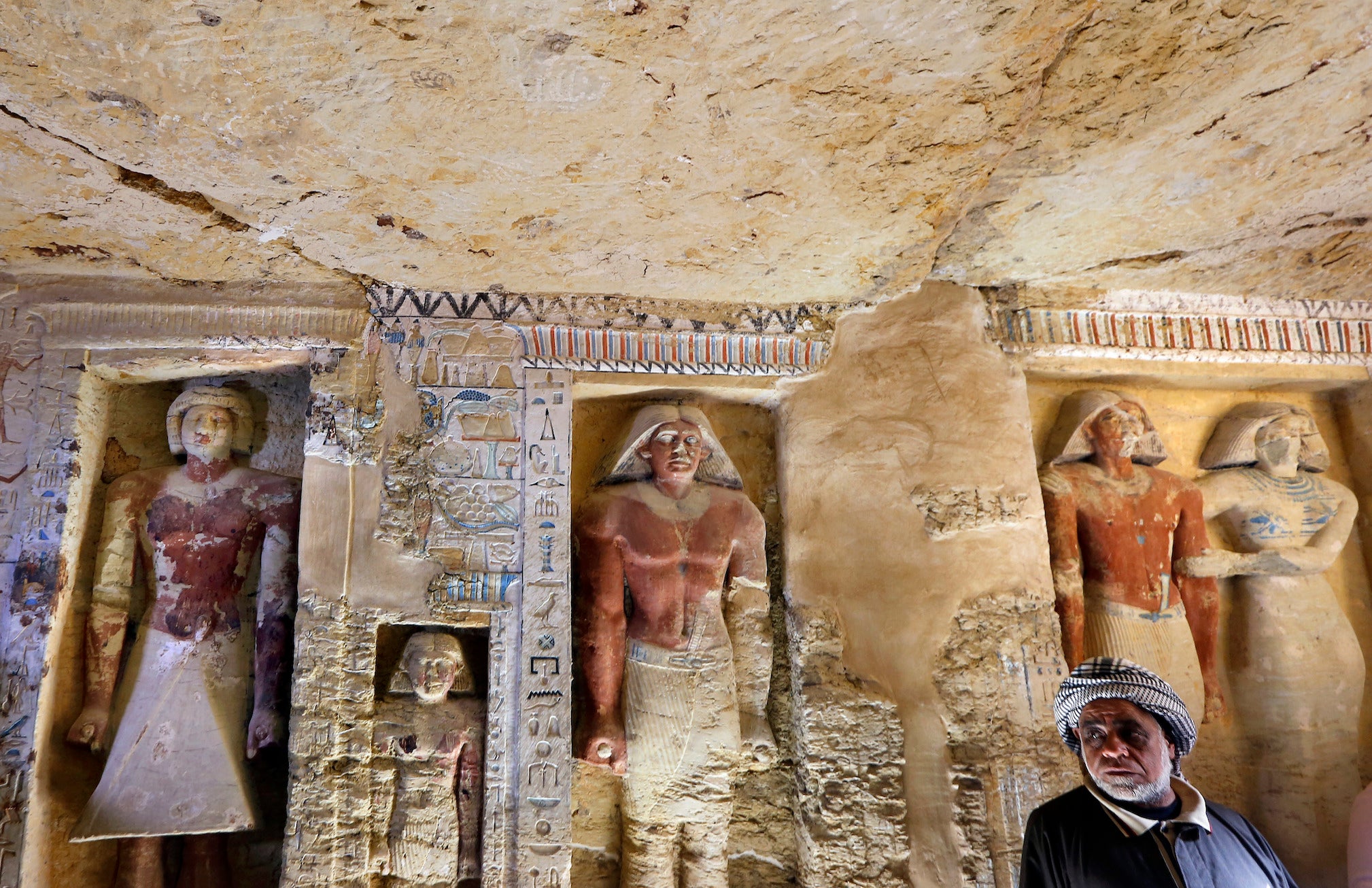 Saeed Abdel Aal, an excavation worker stands at the recently uncovered tomb of Wahtye.