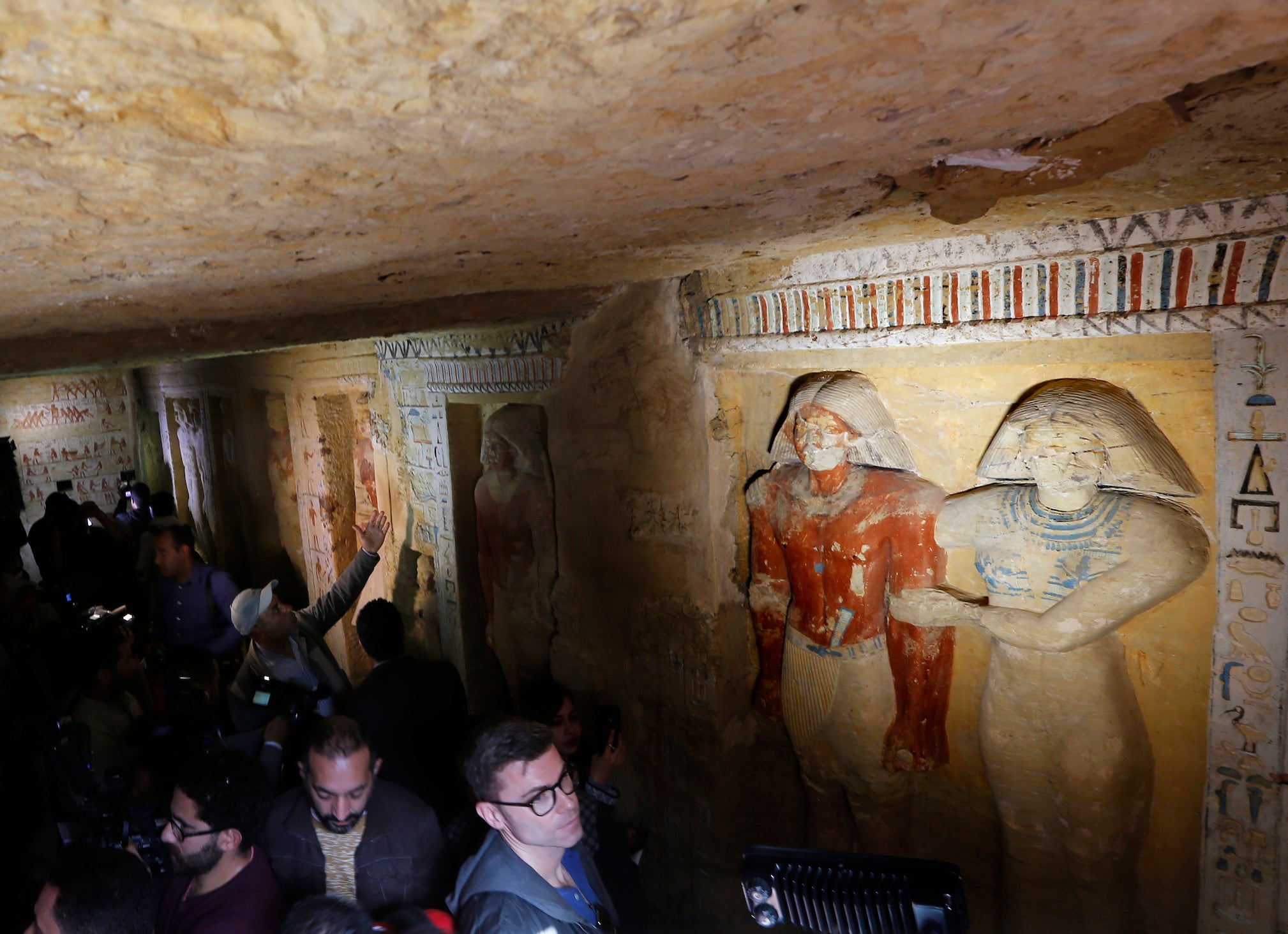 Cameramen and visitors visit the recently uncovered tomb of Wahtye