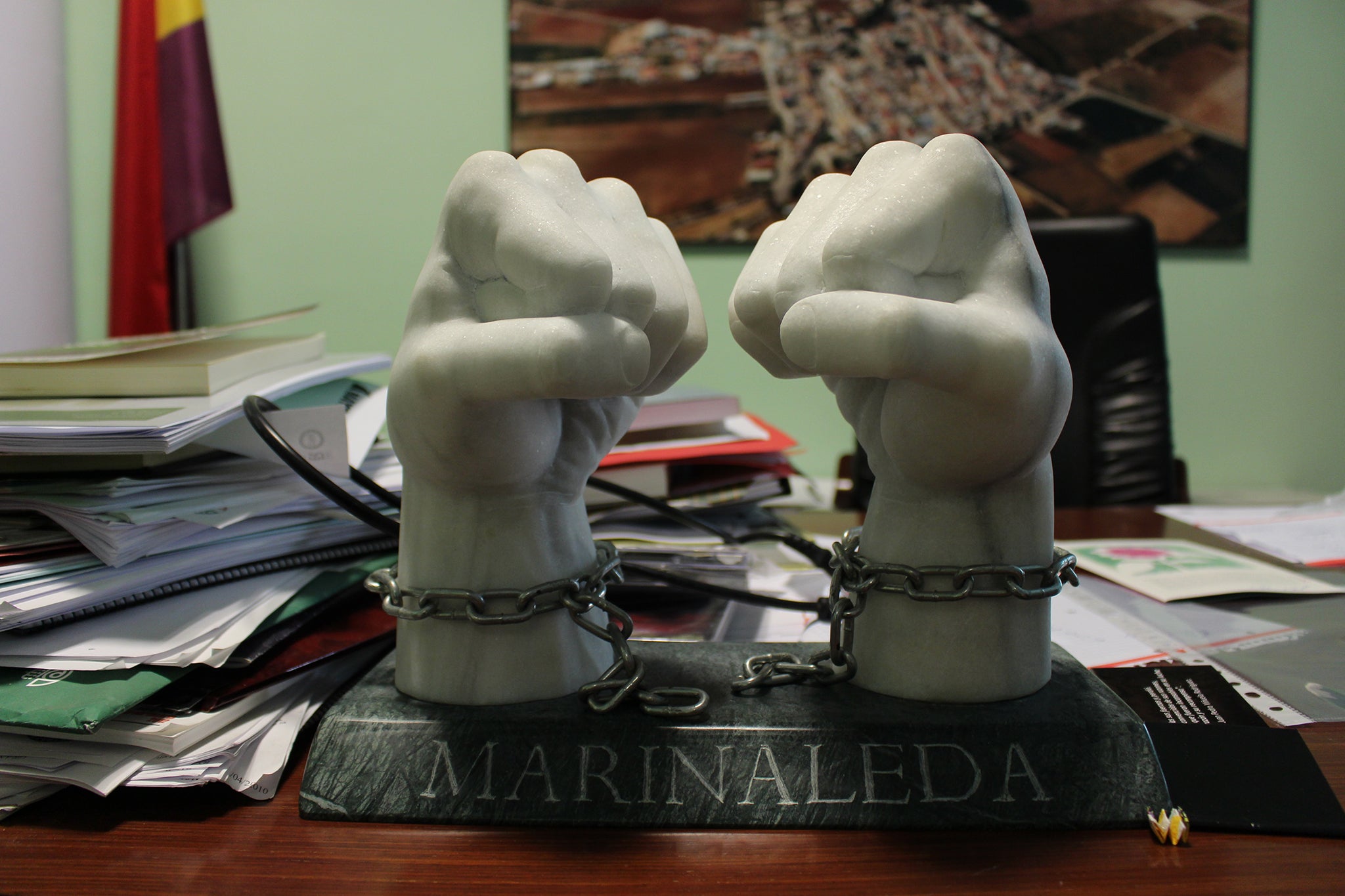 A sculpture of two marble fists takes pride of place on a desk in the office