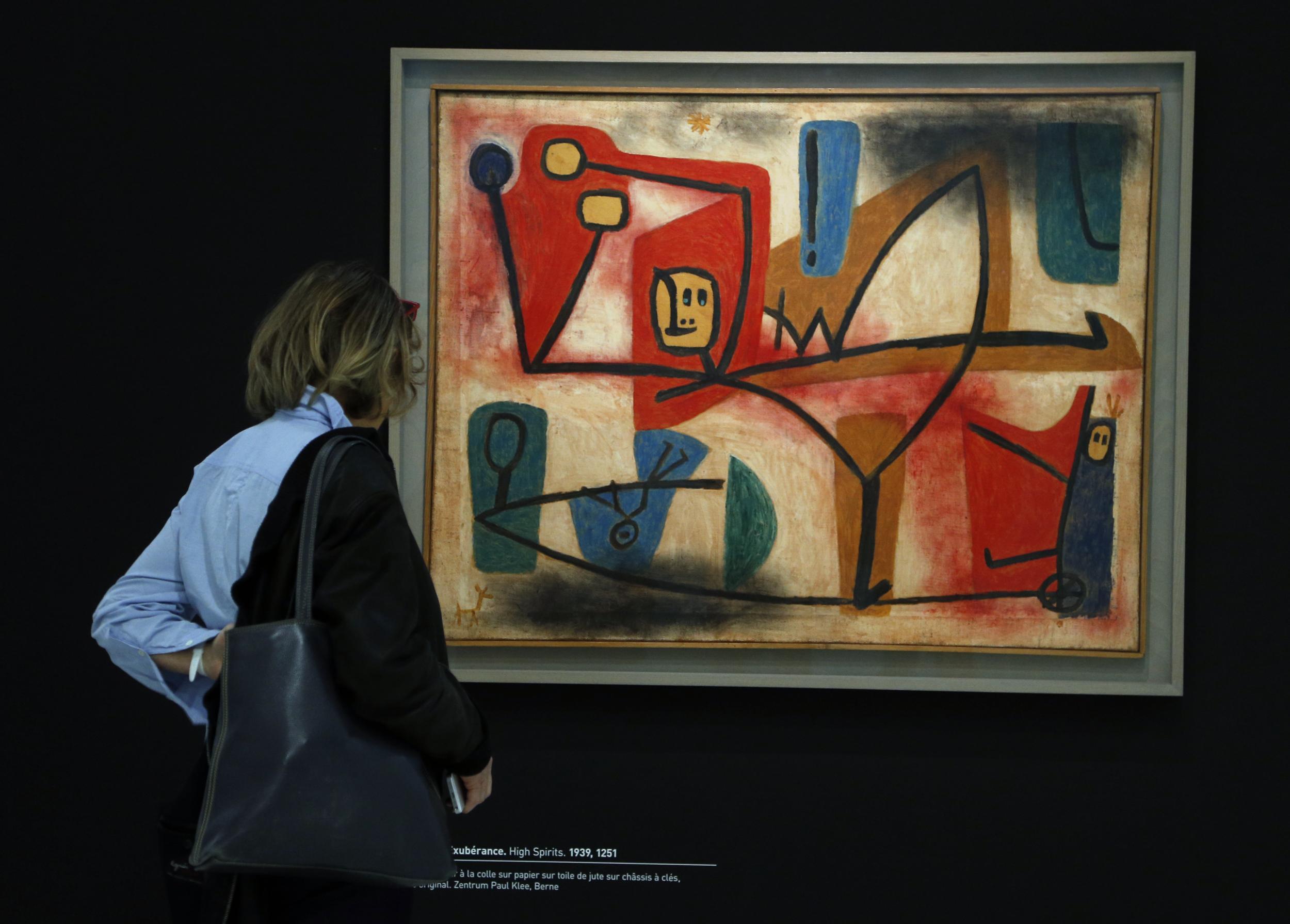 A visitor watches “High Spirits”, a 1939 mixed media painting by German artist Paul Klee, during a press preview at the Georges Pompidou Cultural and Art Centre on 5 April, 2016 in Paris, ahead of the exhibition “Paul Klee, Irony at work” presented through April 6 – August 1, 2016. (FRANCOIS GUILLOT/AFP/Getty Images)