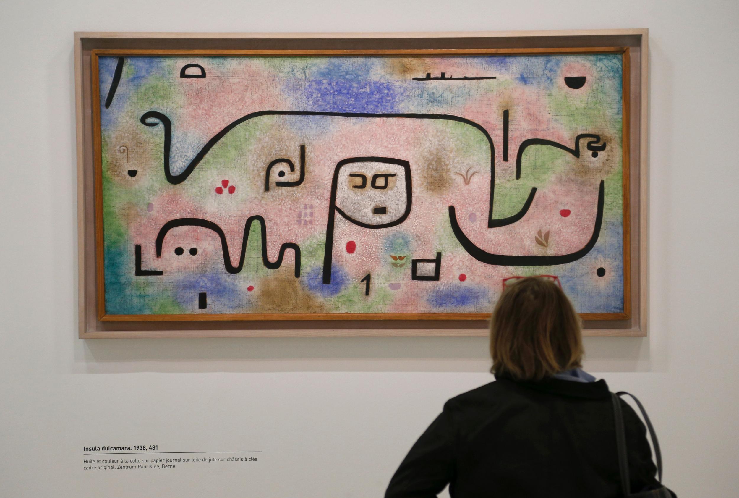 A visitor watches “Insula Dulcamara“, a 1938 mixed media painting by German artist Paul Klee (1879-1940), during the press preview at the Georges Pompidou Cultural and Art Centre on 5 April, 2016 in Paris, ahead of the Paul Klee exhibition “Paul Klee, Irony at work” presented through April 6 – August 1, 2016. (FRANCOIS GUILLOT/AFP/Getty Images)