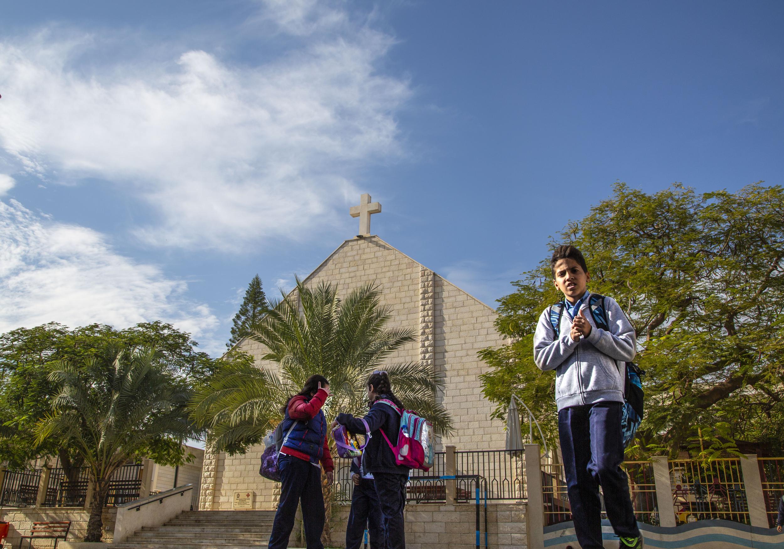 School children play outside in the courtyard of the Holy Family Church in Gaza