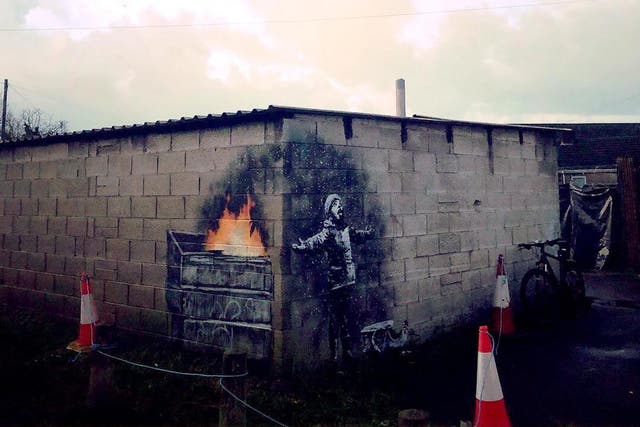 The garage artwork shows a child trying to catch ‘snowflakes’ with their tongue