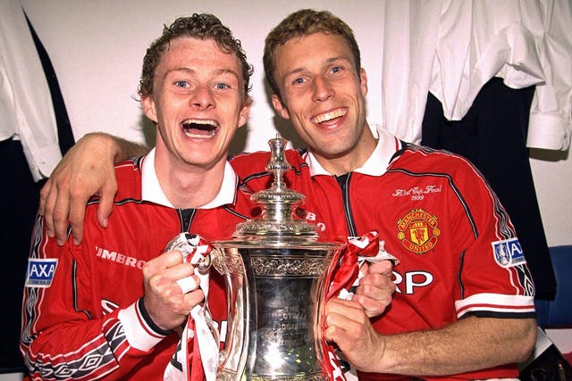 Ole Gunnar Solskjaer and Ronny Johnson celebrate in the dressing room with the FA Cup