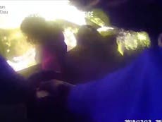 Police bodycam footage shows man being rescued from burning car