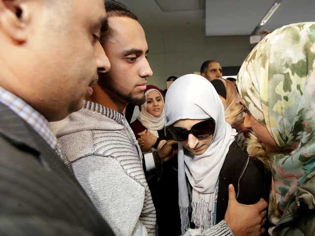 Shaima Swileh stands with her husband Ali Hassan after she arrived at San Francisco International Airport